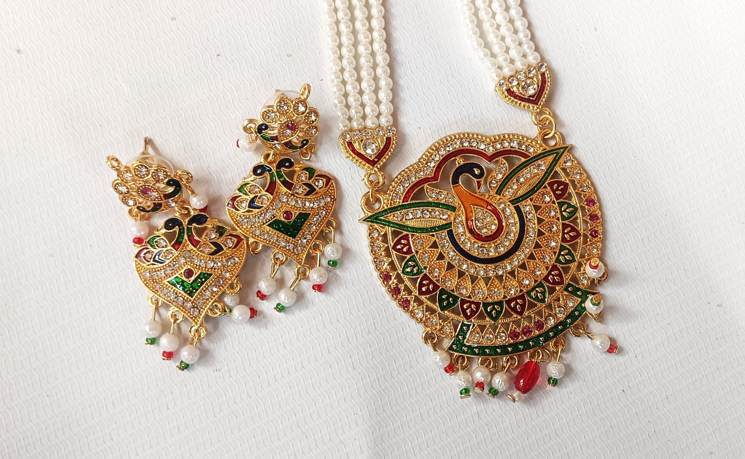 Rajasthani pearl beaded imitation necklace set with a peacock design pendant and matching Earrings.